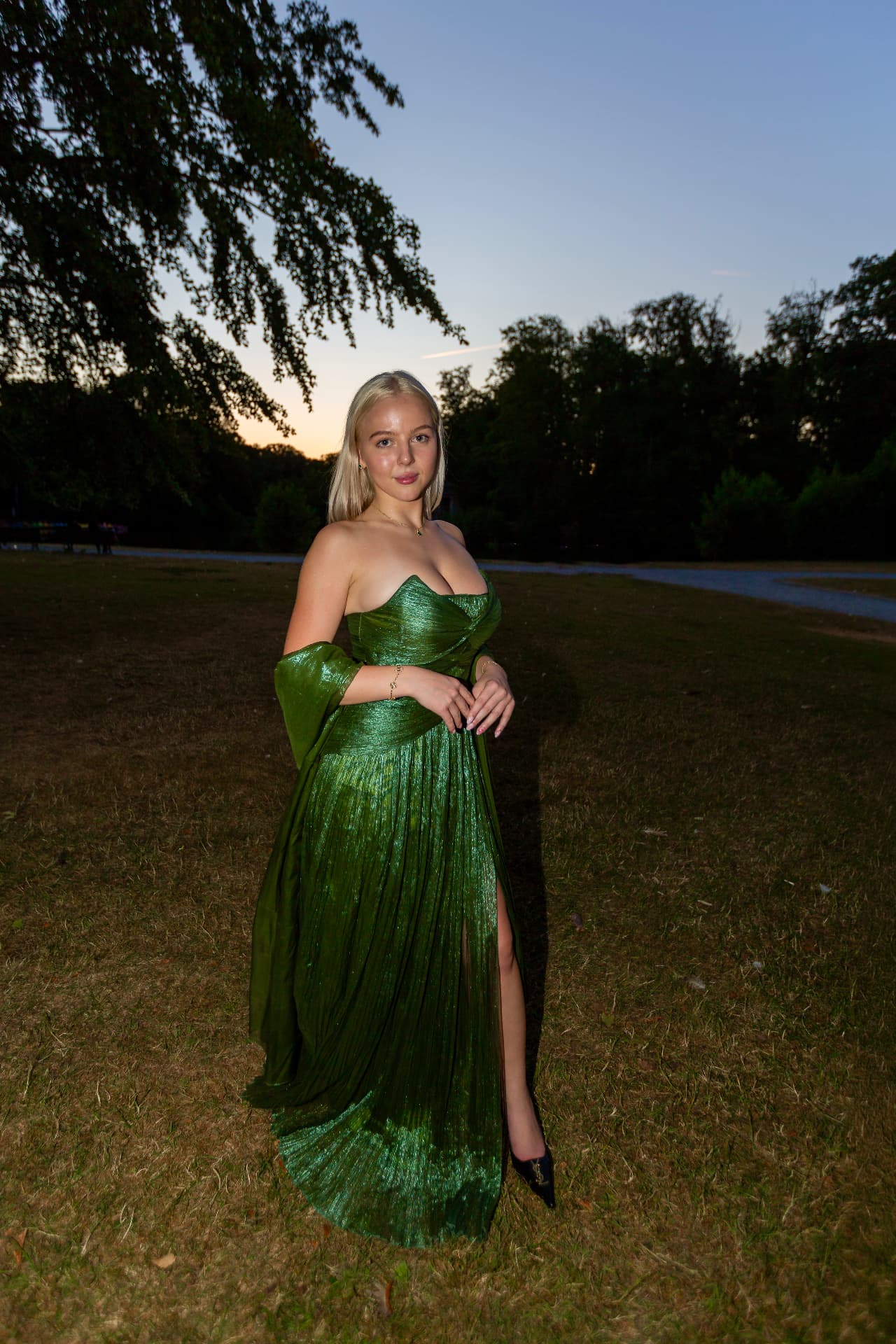 Mercedes Reuter in a green evening gown at sunset during an editorial fashion shoot